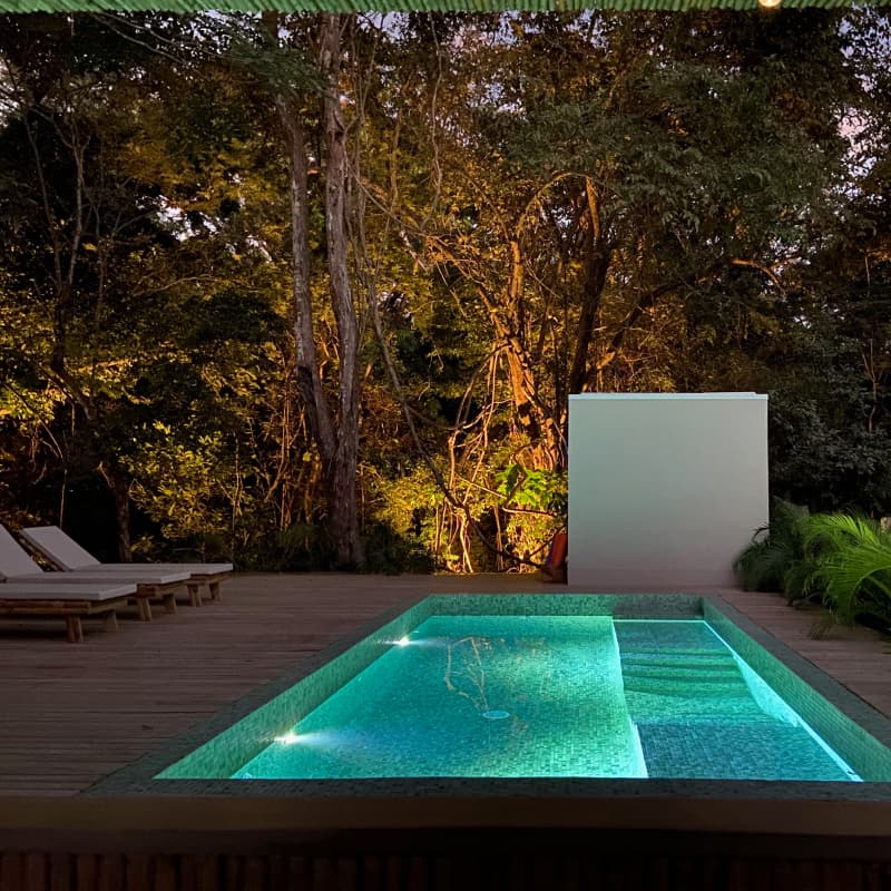 View of the salt pool at night with lights in the jungle