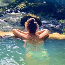 Person enjoying hot springs at Rio Negro