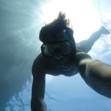 Person under water doing snorkeling