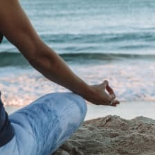 Person doing yoga on the beach